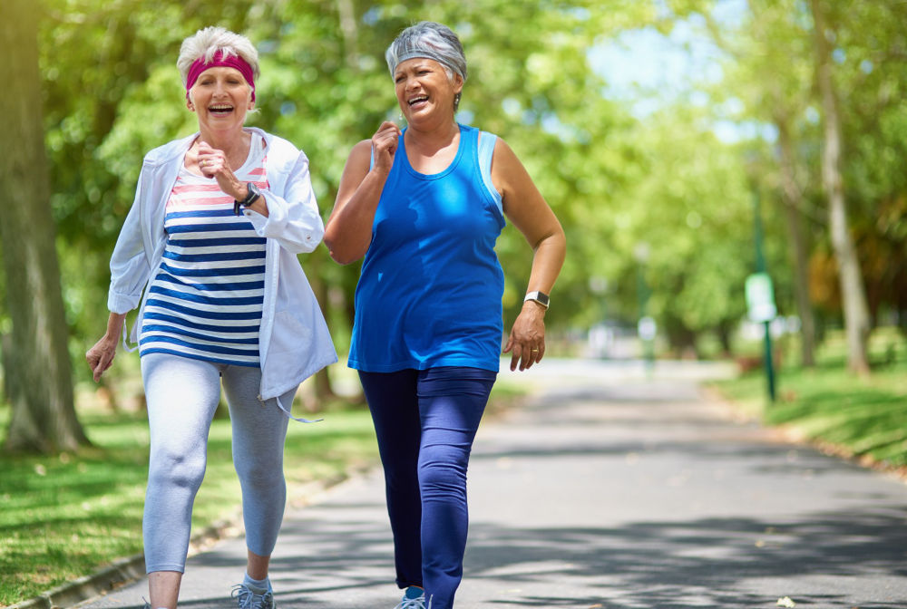 Shot of two elderly friends enjoying a run together outdoors