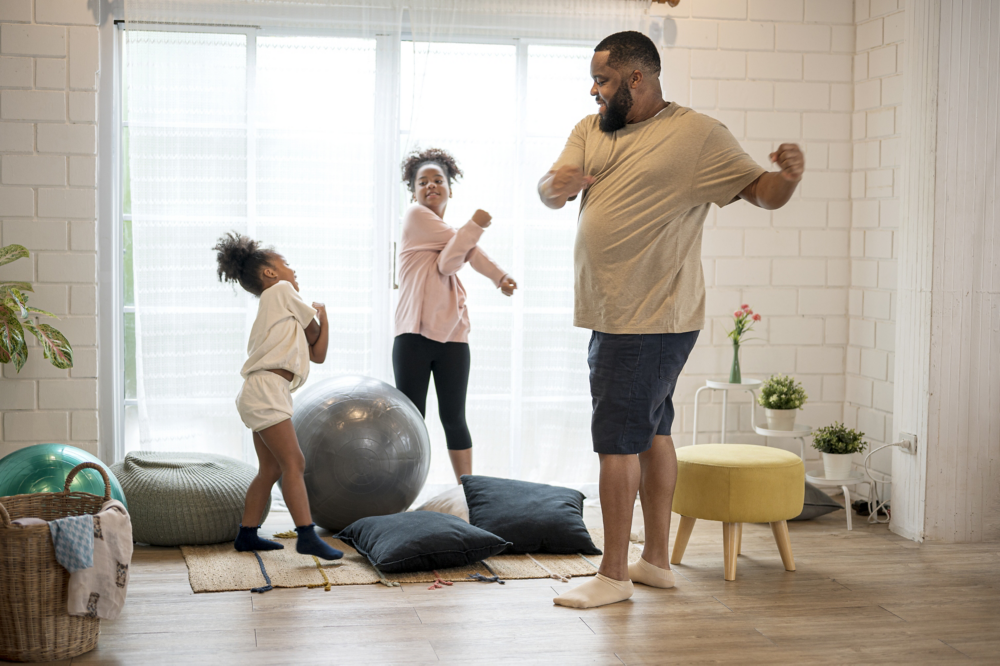 African father and his two daughter morning exercise at home.