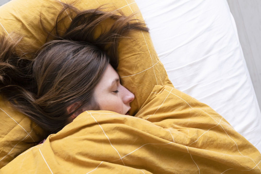 A woman sleeping in bed.