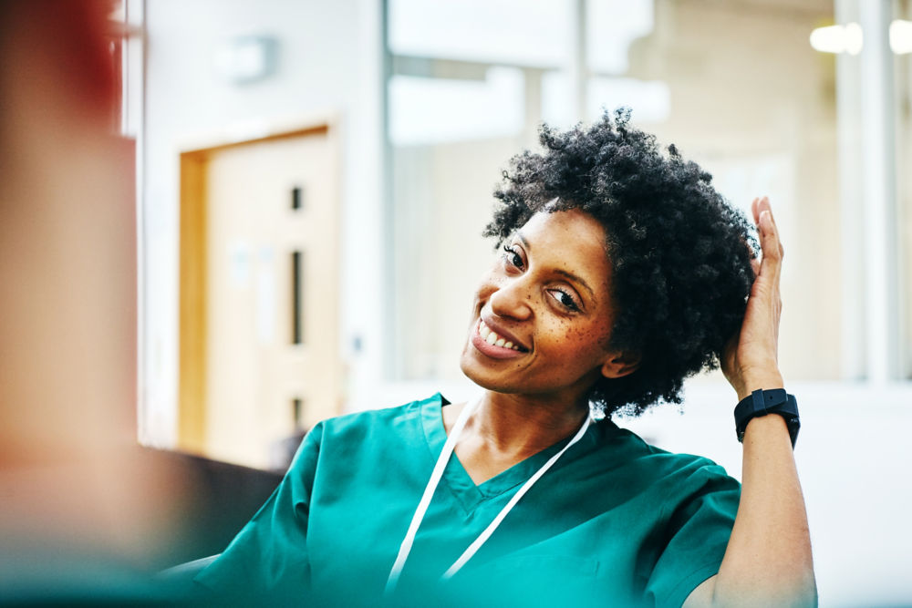 happy young african female medic relaxing during work break