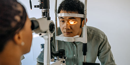 A young man is getting eye laser procedure.