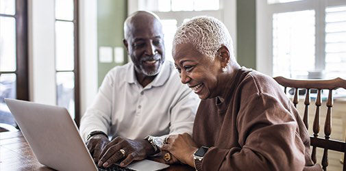 Man and woman are looking medicare rewards helpful tips on laptop.