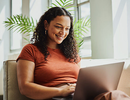 smiling girl on computer at home