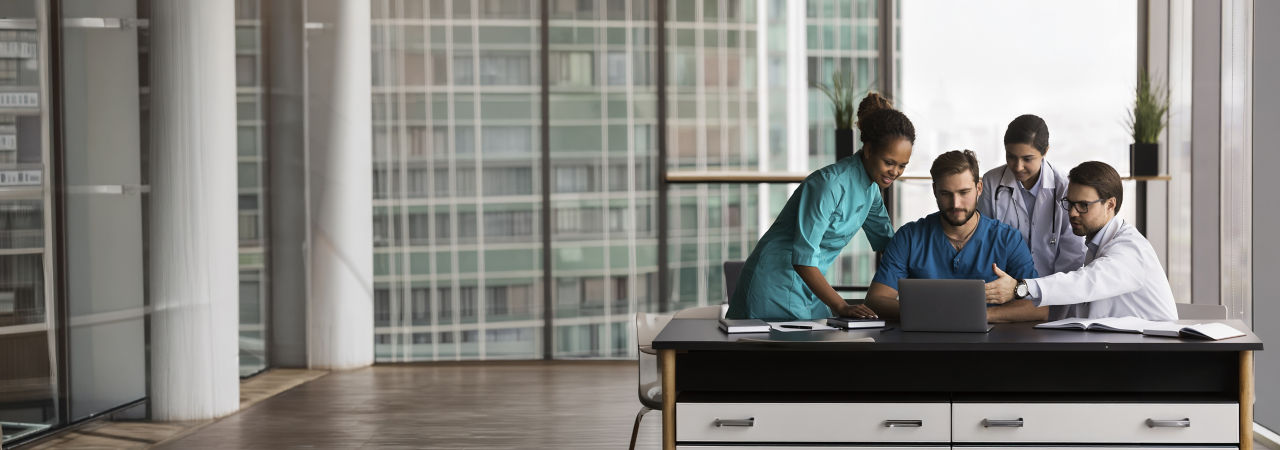 group of healthcare providers around a computer 