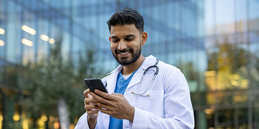 doctor looking at phone outside