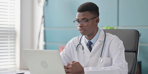 Doctor working on laptop in office