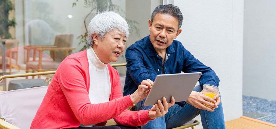 two seniors looking at a tablet