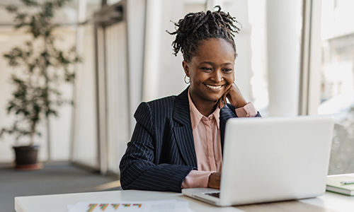 A smiling businesswoman working at her laptop