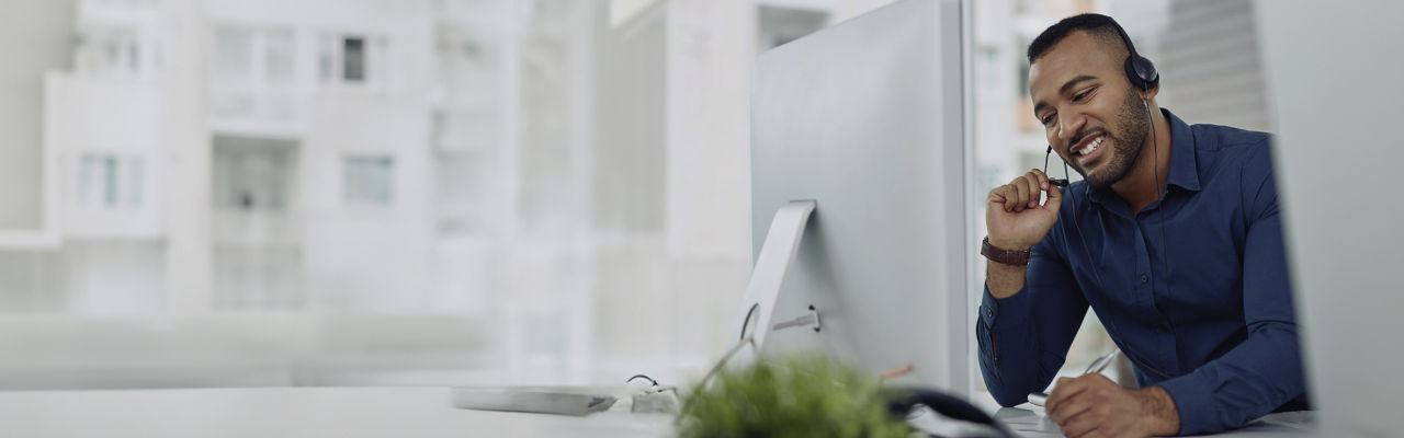 agente de ventas con auriculares en la computadora