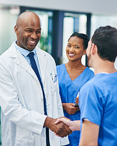 Shot of confident young doctors shaking hands in a modern hospital