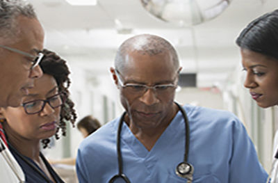 Doctors and nurses reviewing medical chart in hospital