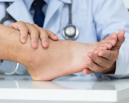Podiatrist examining foot