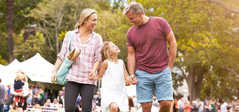 family holding hands at an outdoor event