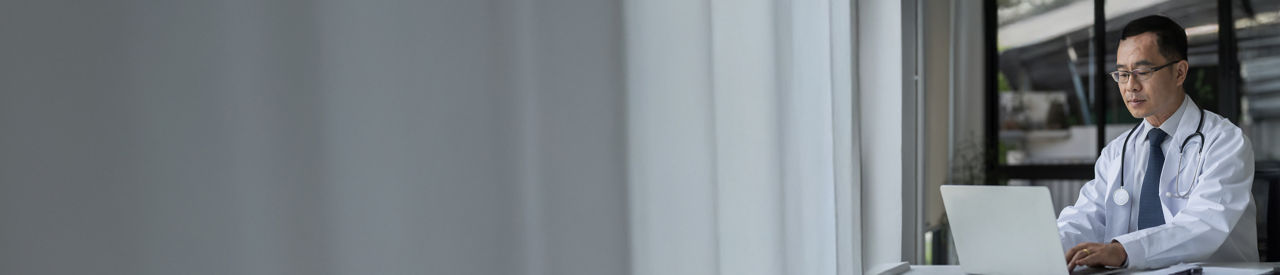 Male doctor on computer in the office.