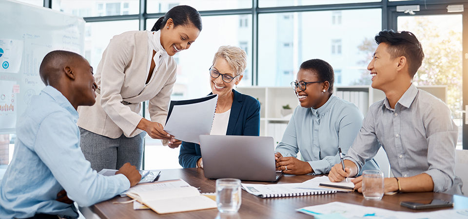 A group of business people around computer