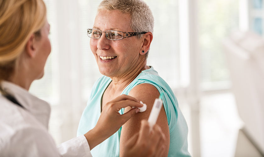 Senior woman receiving vaccine at the doctor's office.