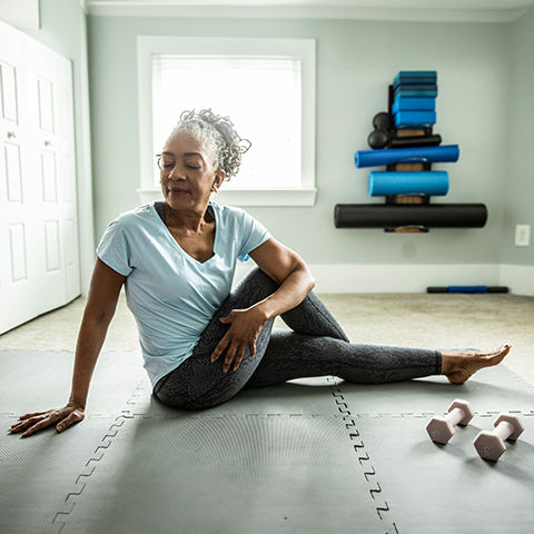 African-American woman stretching at home