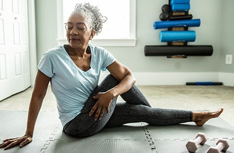 African-American woman stretching at home