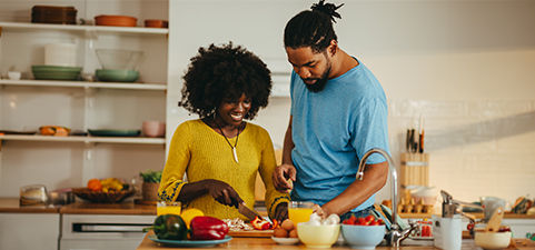 two people cooking in the kitchen 