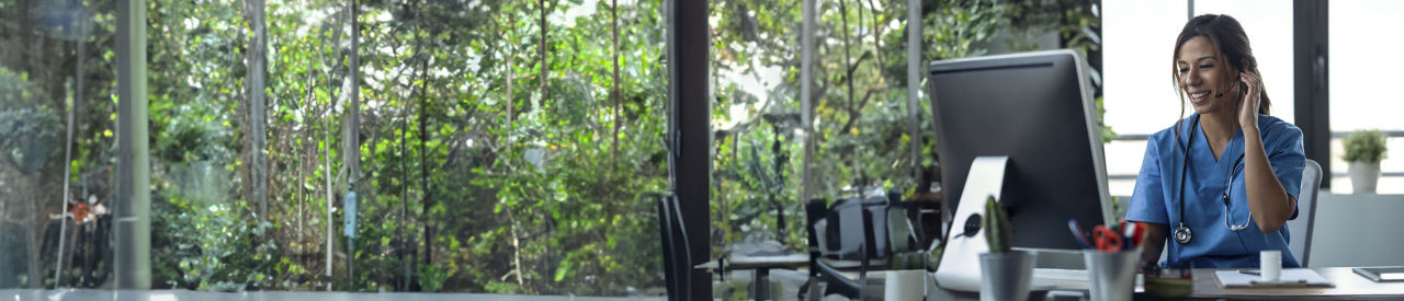 healthcare provider looking at laptop in office