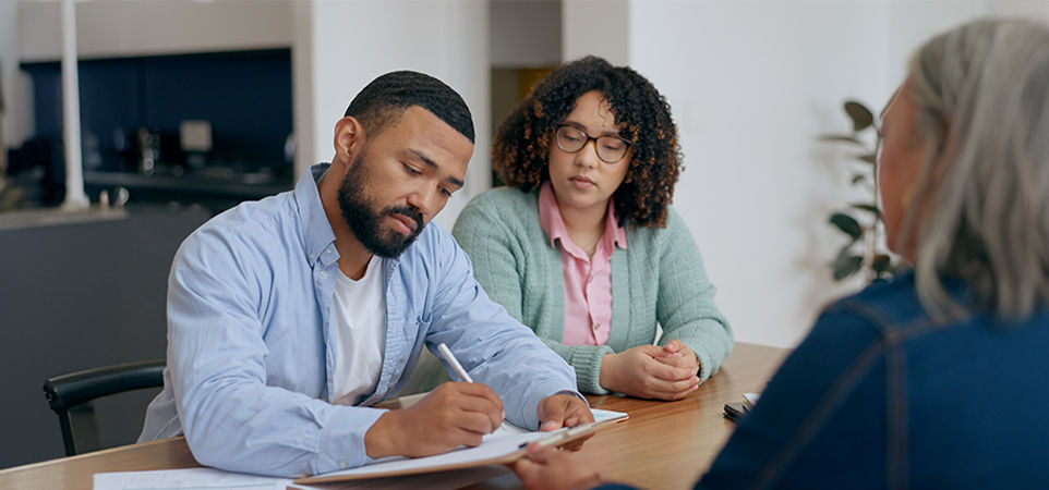 Male and female are signing a form