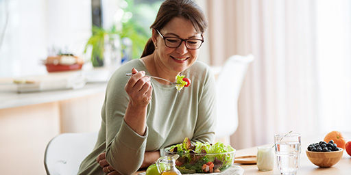 mujer comiendo ensalada saludable