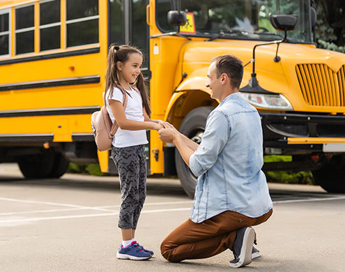 Happy day of back to school. Smiling father taking child to primary school.