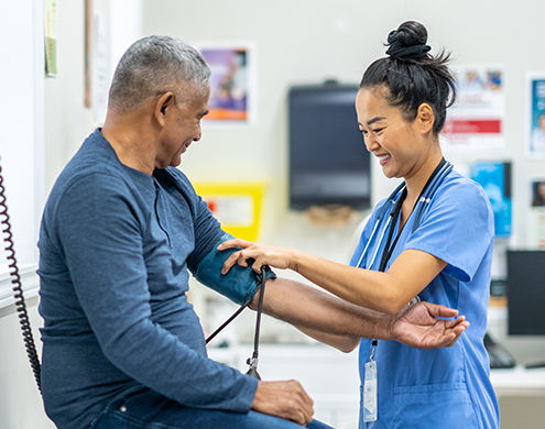 Doctor is checking patient's blood pressure.