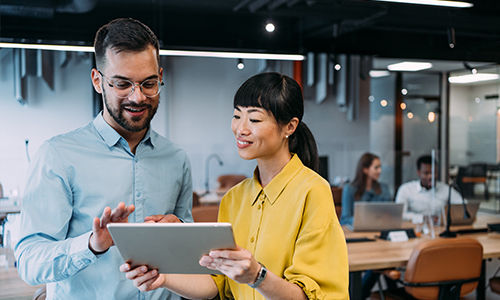 two employees looking at tablet