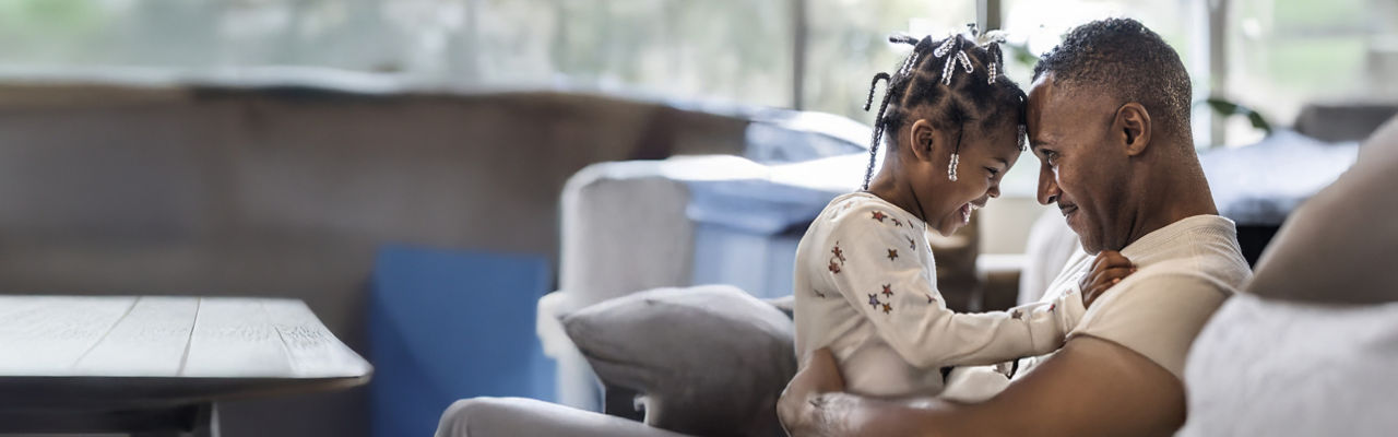 father sitting with young daughter 