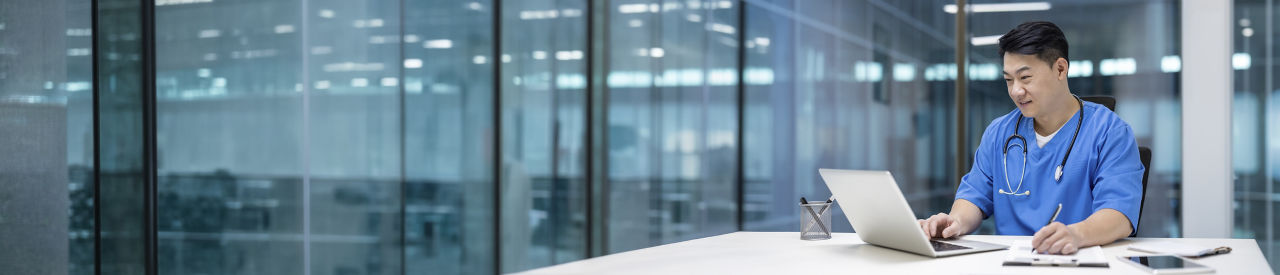 health care provider looking at laptop in office