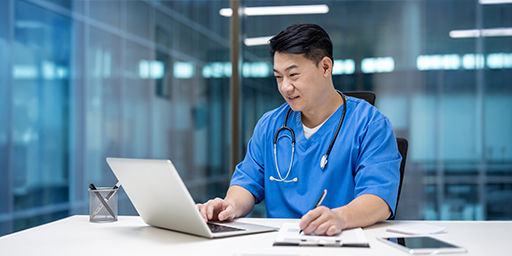 doctor looking at laptop