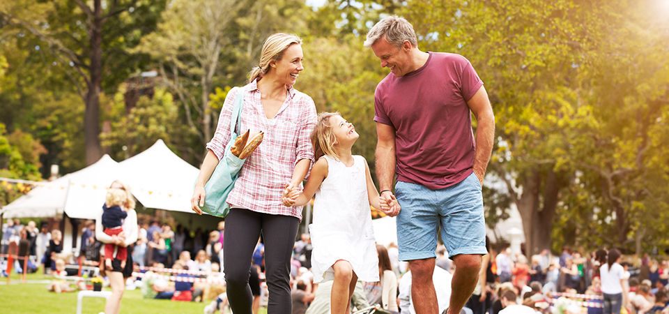family holding hands during outdoor festival