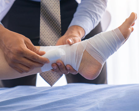 Podiatrist bandaging foot