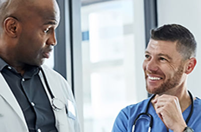 Two medical practitioners consult together in a hospital