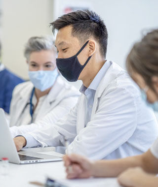 medical professional at laptop