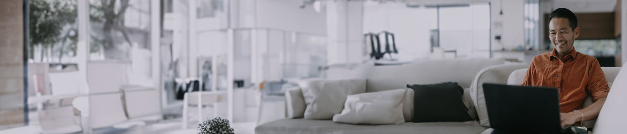 person smiling and looking at laptop