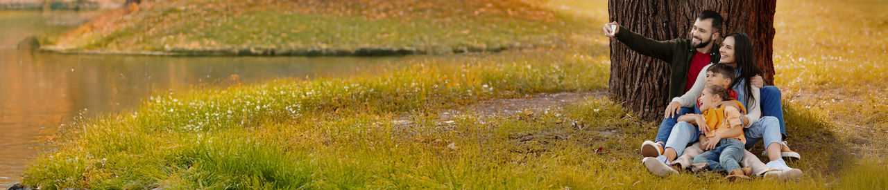 family taking a selfie under a tree