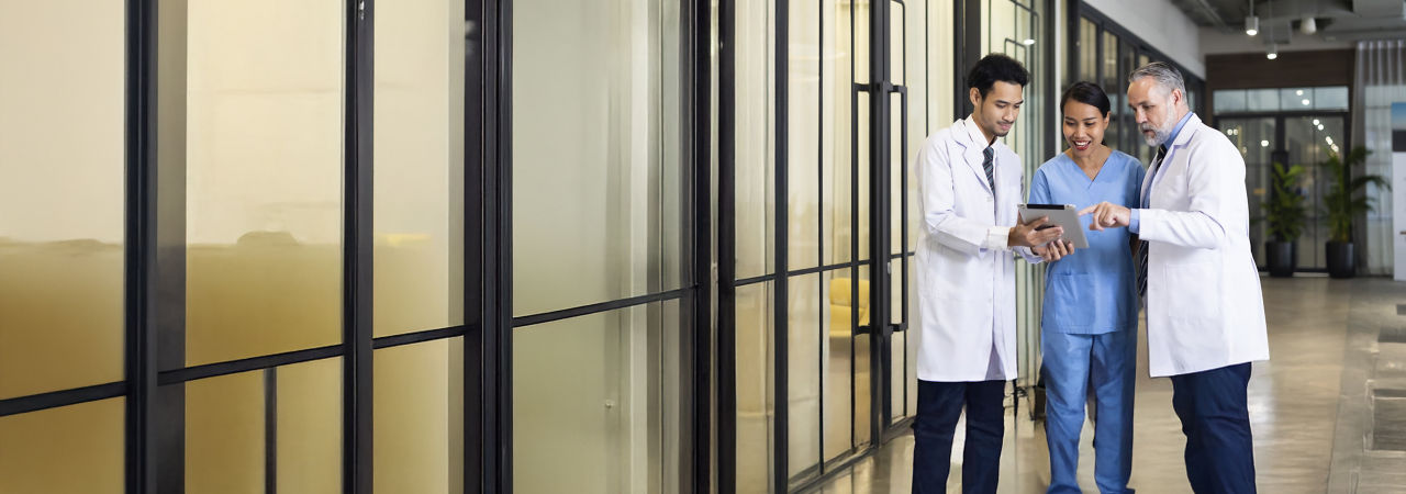 group of health care providers looking at tablet