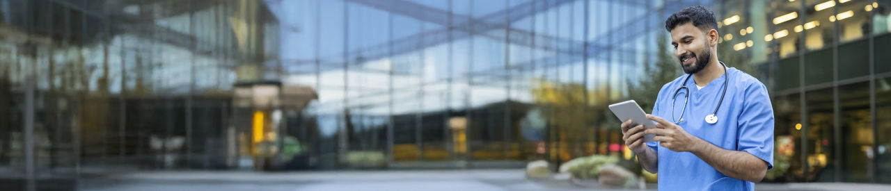 health care provider looking at tablet outside