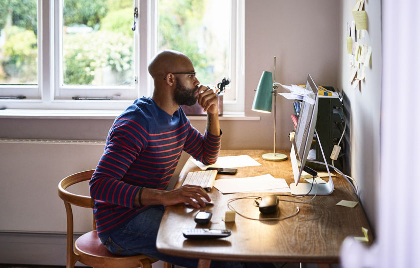 Man using computer at home to complete health assessment