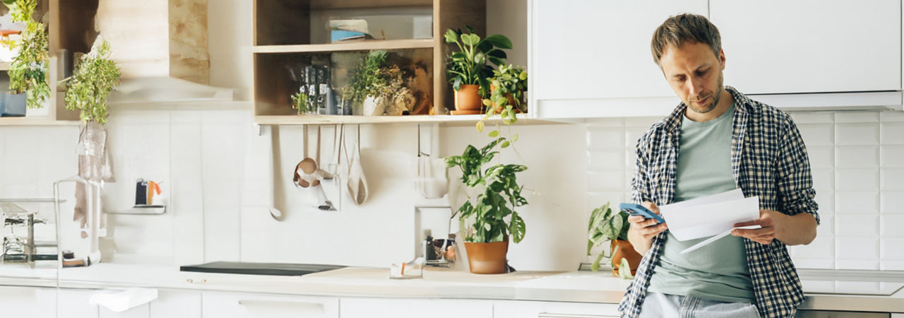person holding cell in kitchen