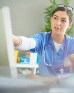 nurse explains by pointing to computer