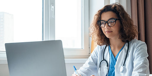 Attractive female doctor make online video call consult patient on laptop. Medical assistant young woman therapist videoconferencing to web camera. Telemedicine concept. Online doctor appointment.