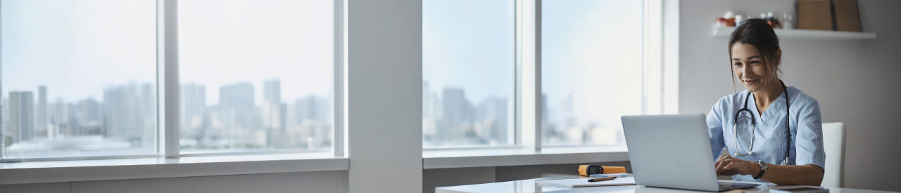 health care provider looking at laptop in office