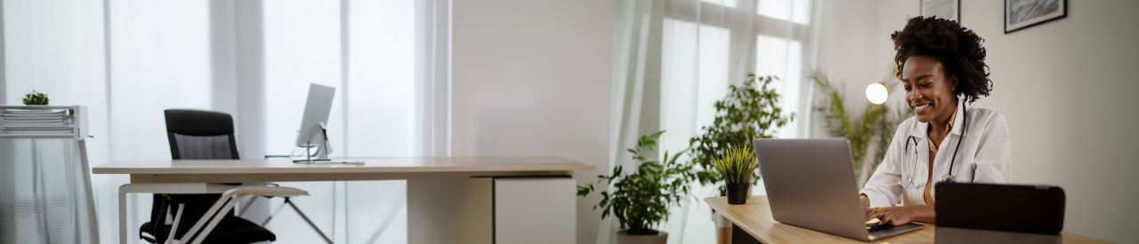 healthcare provider looking at laptop 