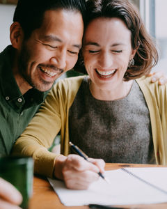 Smiling couple taking notes