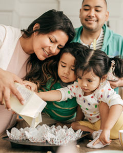 Spanish family preparing desserts