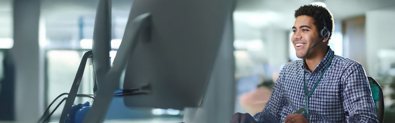telemarketer looking at computer at desk
