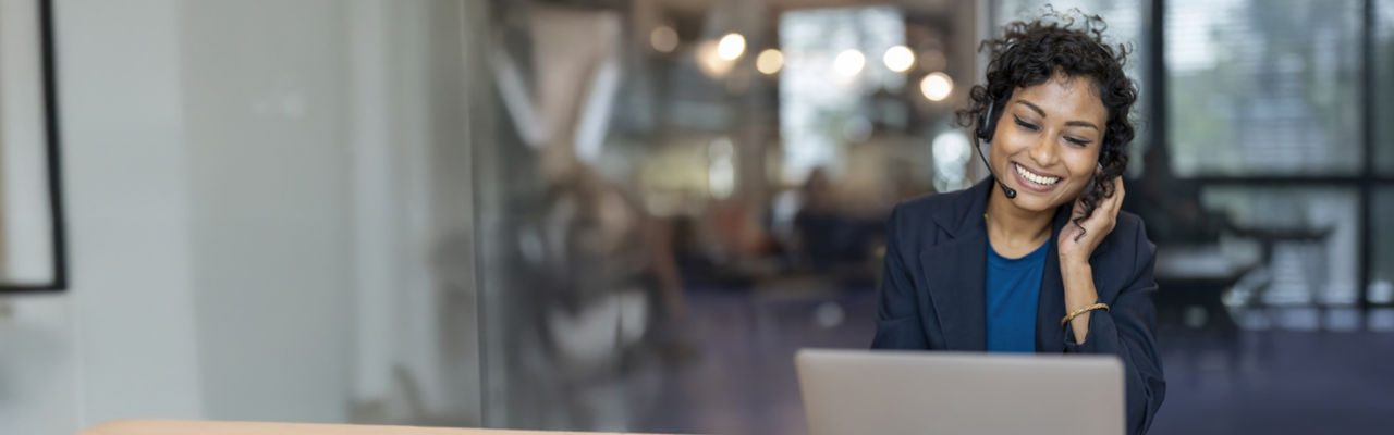 telemarketer with headphones at computer